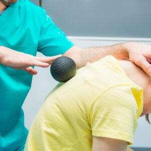 woman receiving ball massage as part of physiotherapy