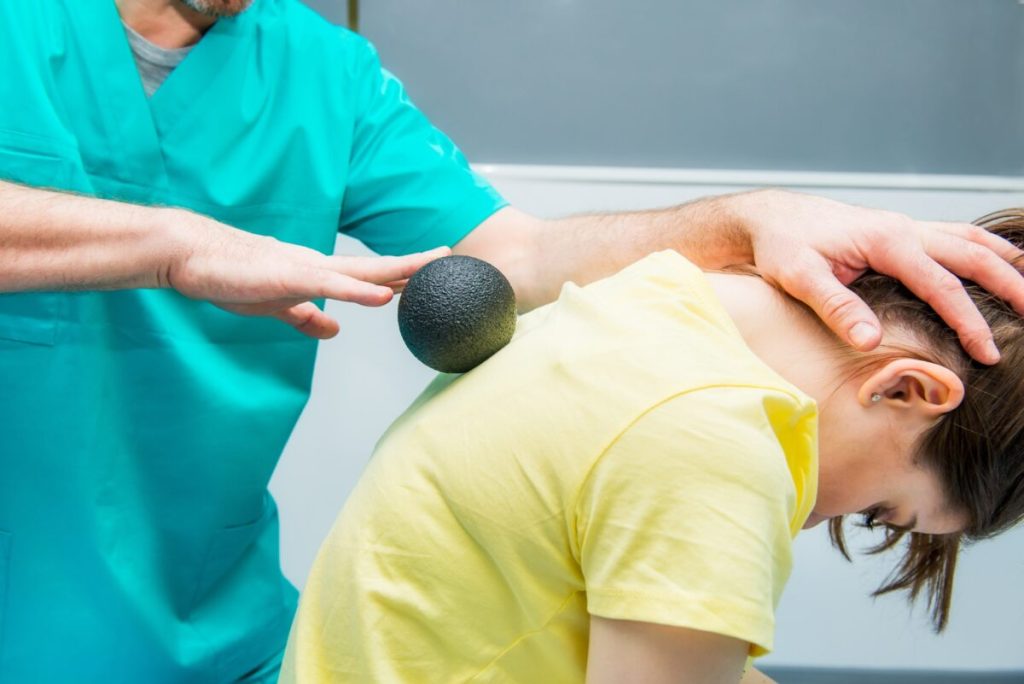 woman receiving ball massage as part of physiotherapy
