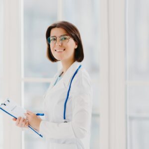 doctor-smiling-while-holding-her-physician-cv