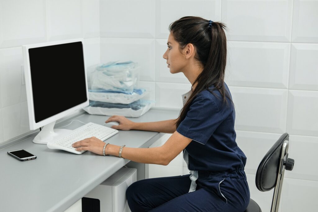 medical assistant working on a computer