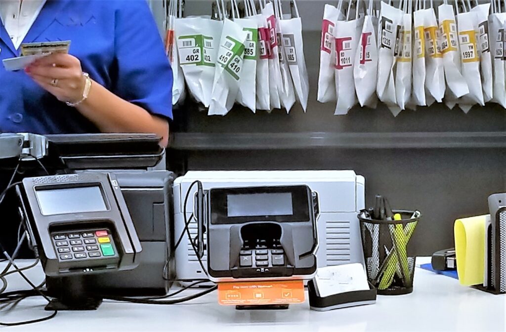 pharmacy technician serving customers on the counter