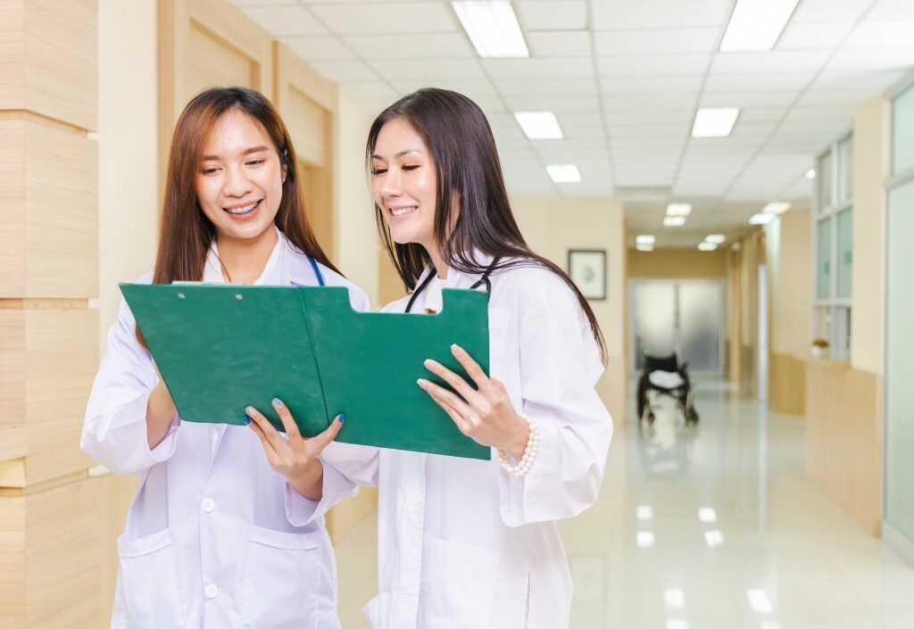 Two nurses happy while sharing experiences on job interview