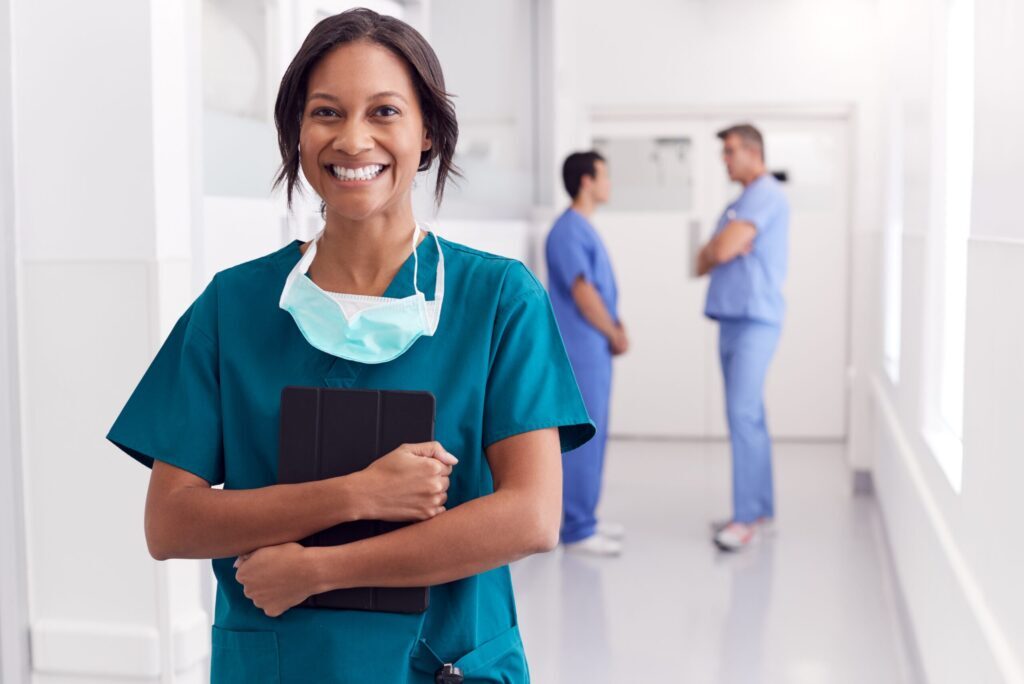 A woman in medical technology field happy holding document.