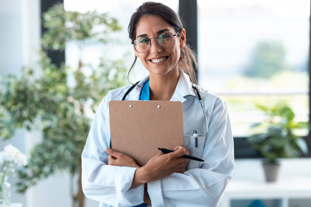 Happy female doctor holding documents.