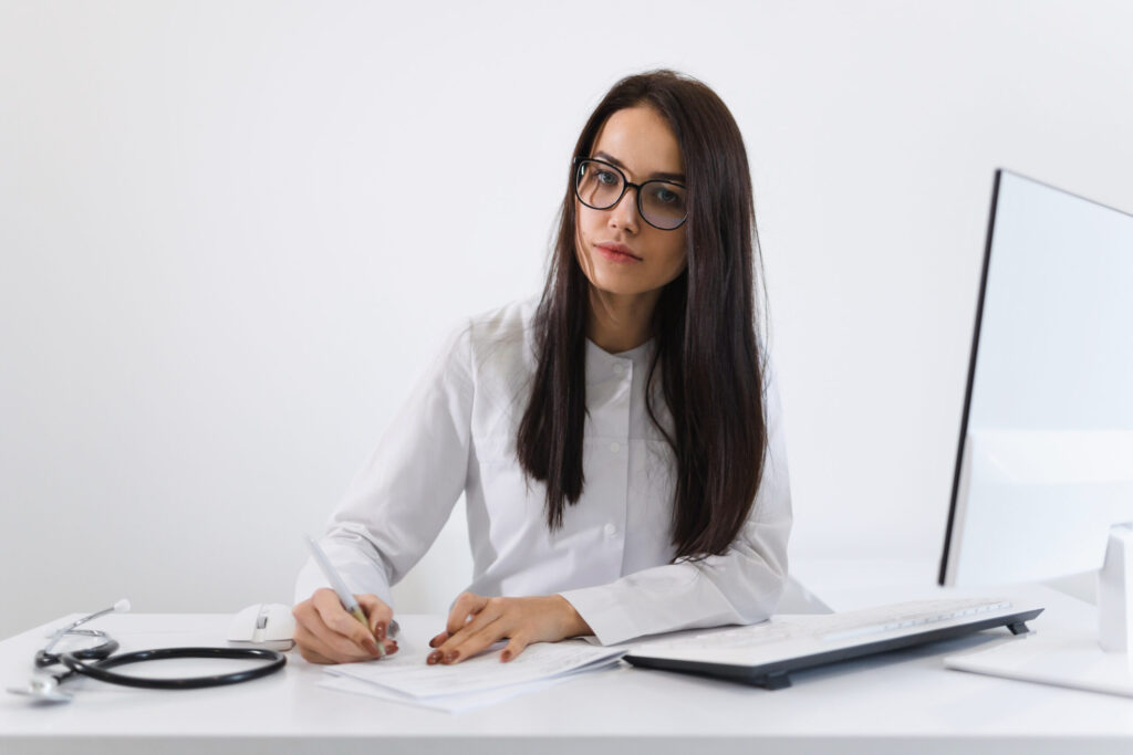 A woman writing a resume for job application.