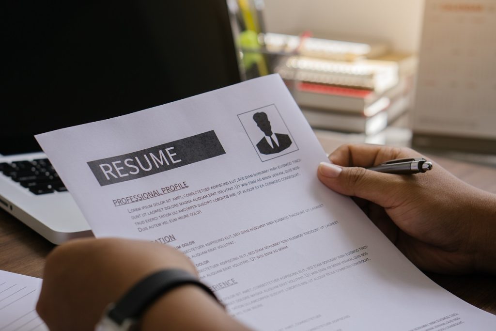 A person writing resume outline
