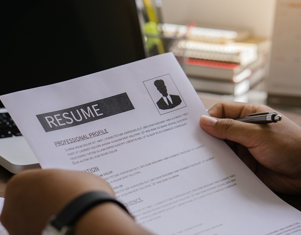 A person writing resume outline