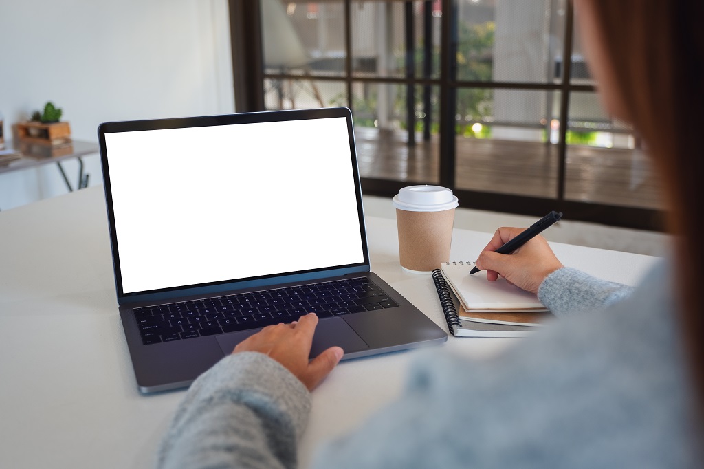 A woman typing on laptop choosing a resume font to use