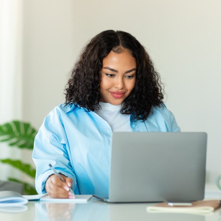 A woman writing resume choosing what to use for resume fonts