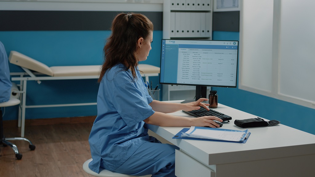 a medical billing specialist diligently encoding patient records for billing purposes