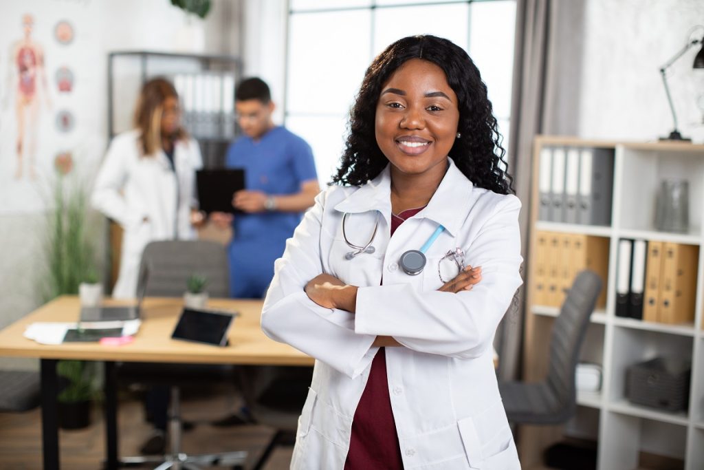 a confident healthcare business analyst with arms crossed