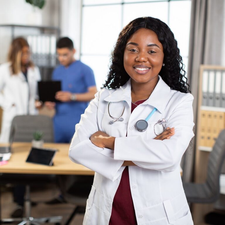 a confident healthcare business analyst with arms crossed