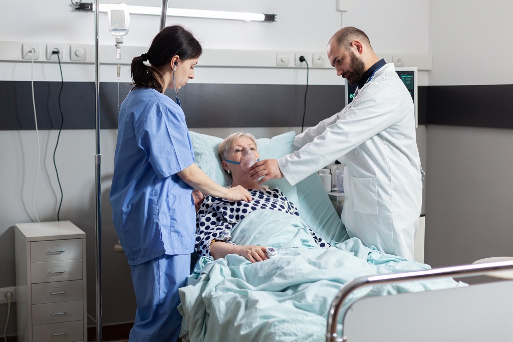 a medical assistant helping a doctor during a patient examination