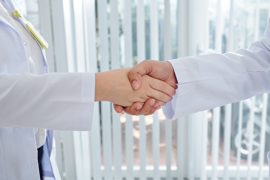 a successful job interview between a confident medical assistant applicant and the head doctor
