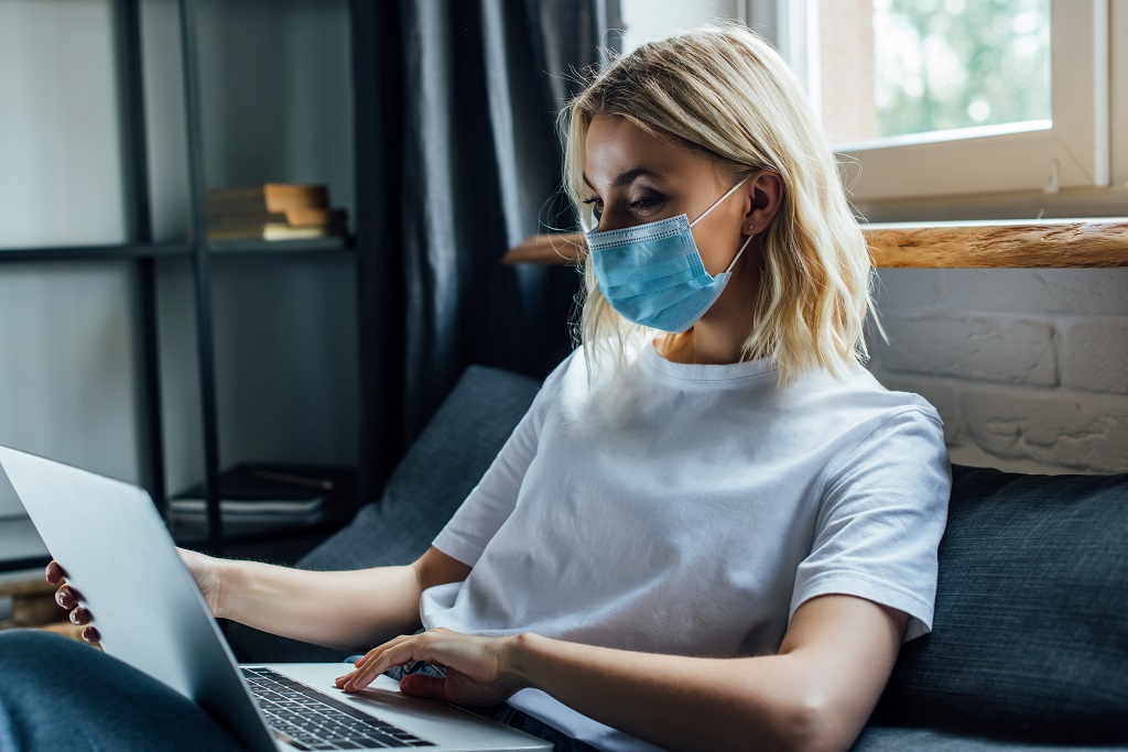 an aspiring medical professional using a laptop to search for essential medical assistant resume skills