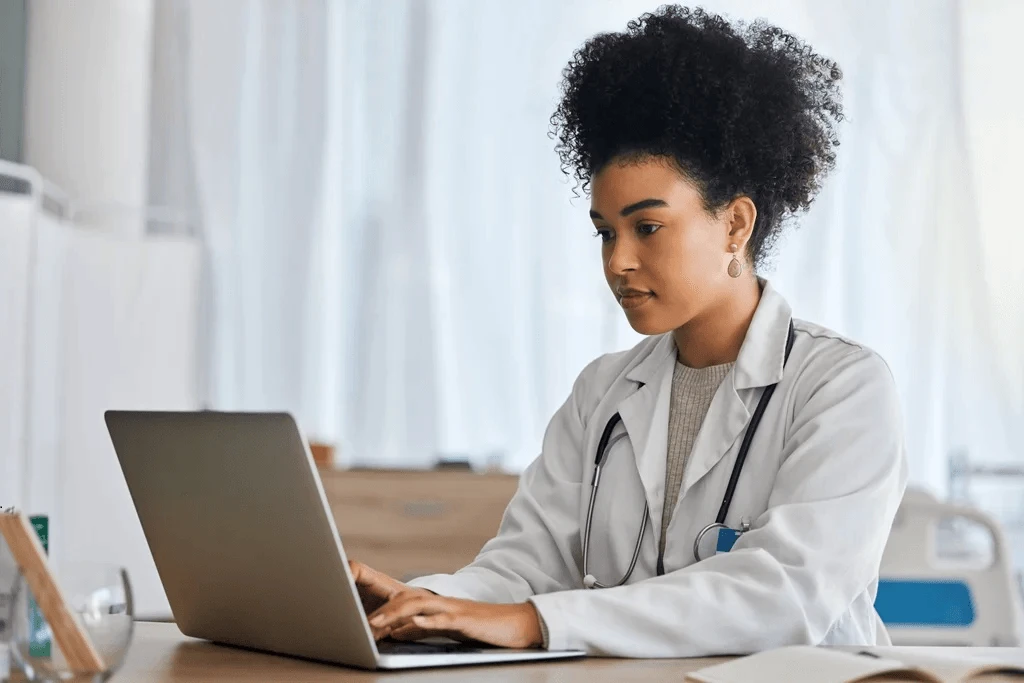 student writing her medical school resume on a laptop