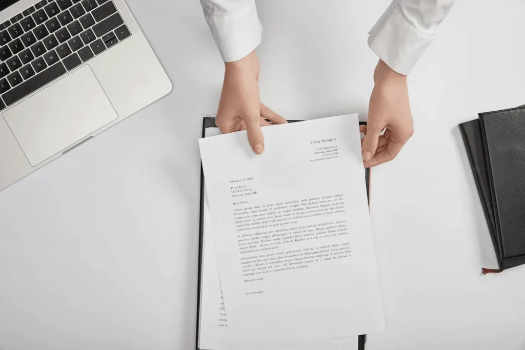 job seeker handing a cover letter during an interview