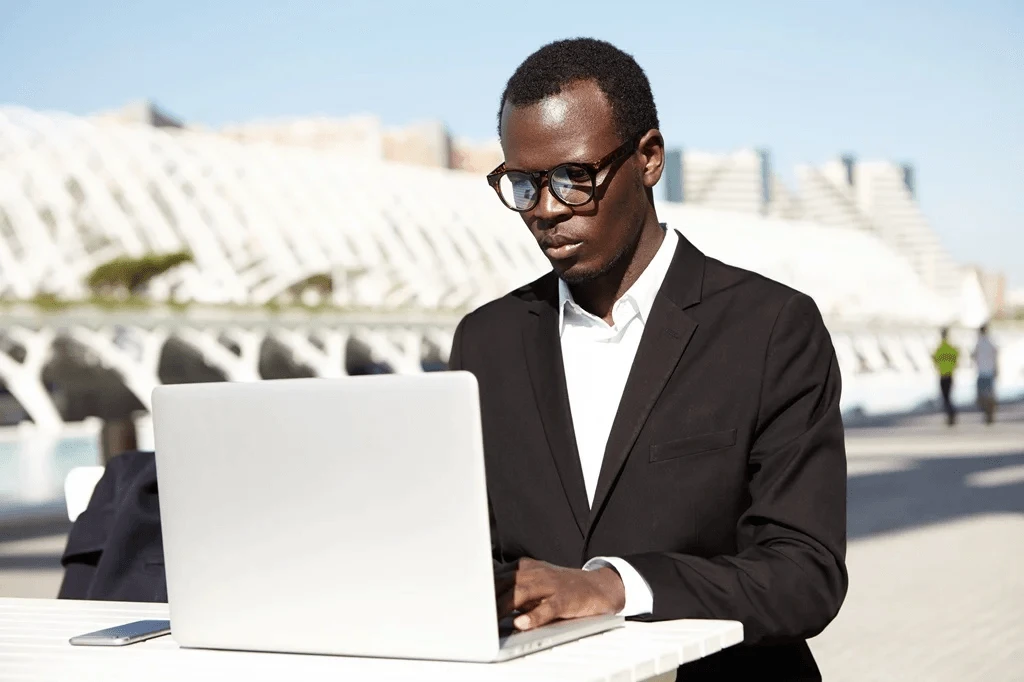 job seeker researching how to write an effective cover letter using his laptop