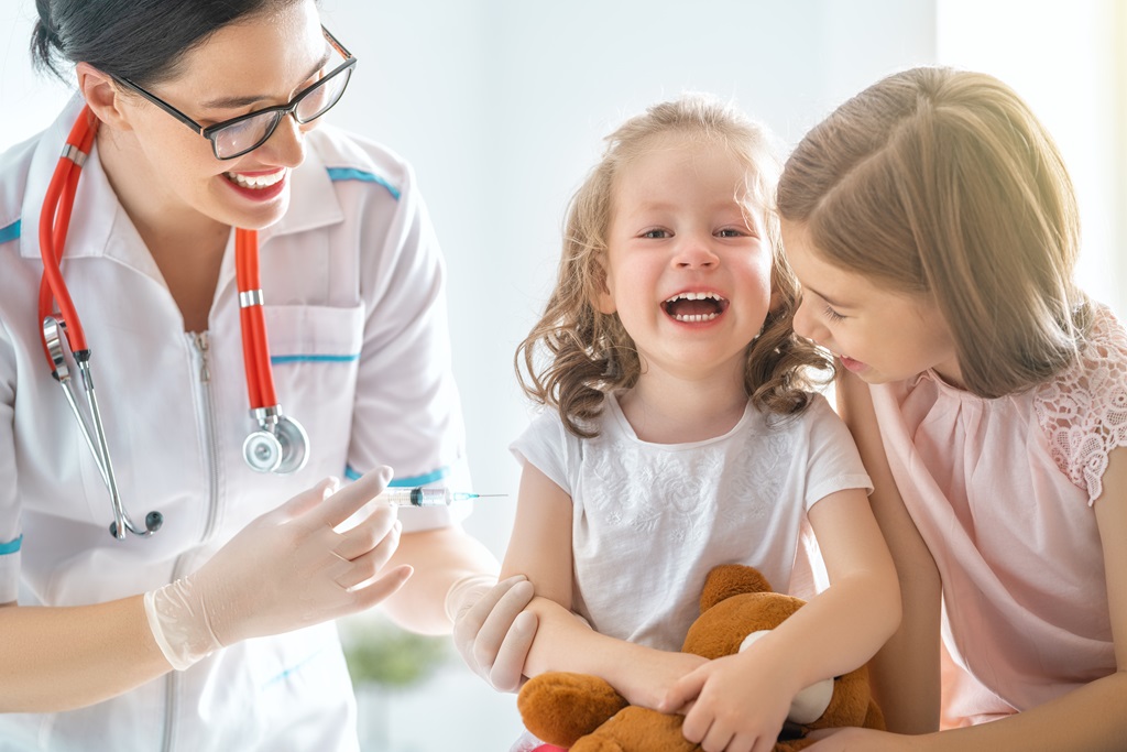 a nurse entertaining her young patients