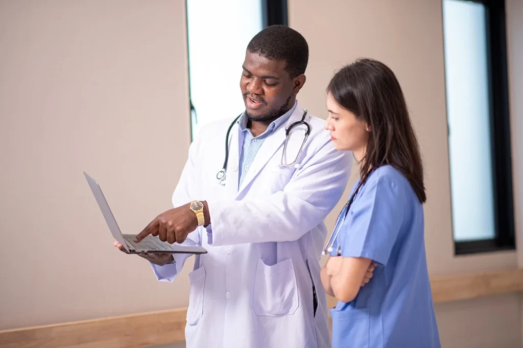 physician and his assistant reviewing the schedule together