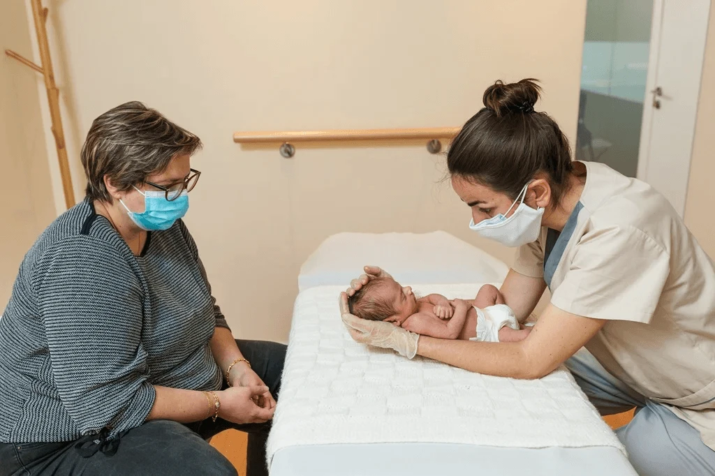 midwife carefully handling an infant