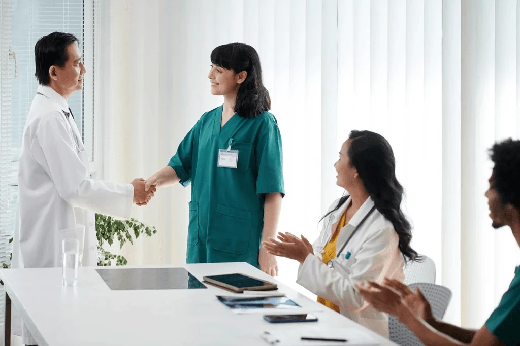 newly hired nurse shaking hands with a doctor