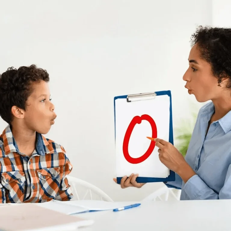 speech language pathologist teaching her young patient to pronounce a letter 1