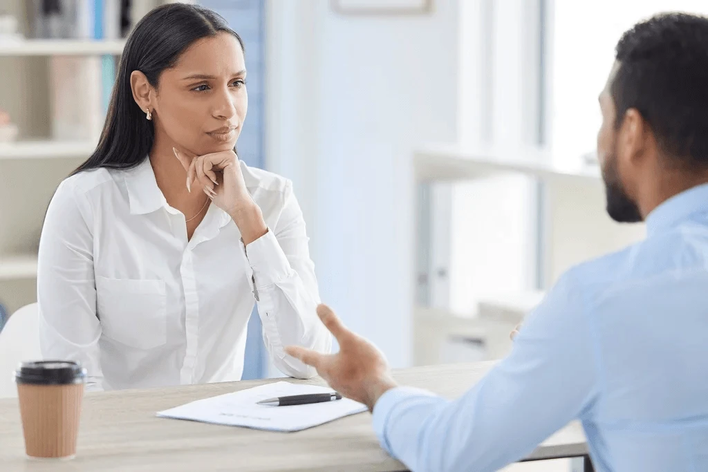 female recruiter assessing the answer of the applicant through behavioral interview questions