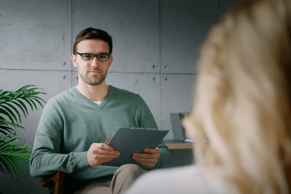 male recruiter asking behavioral interview questions to job applicant