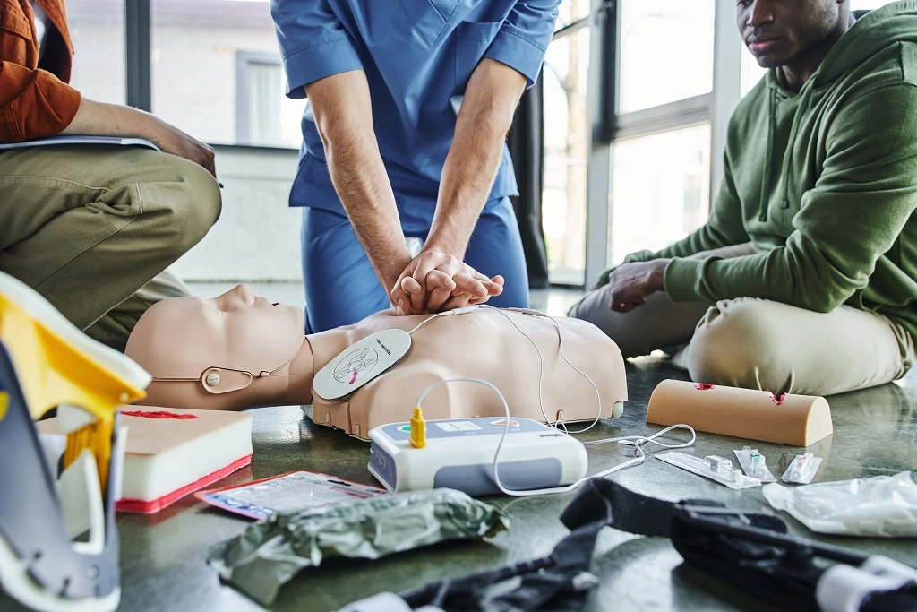 nurse performing cpr training on a manikin highlighting cpr certification on resume
