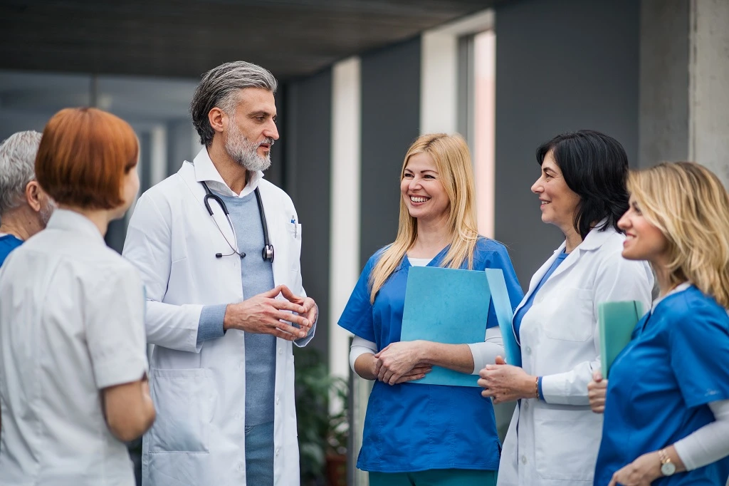 medical team discussing nurse practitioner interview questions in a collaborative hospital setting