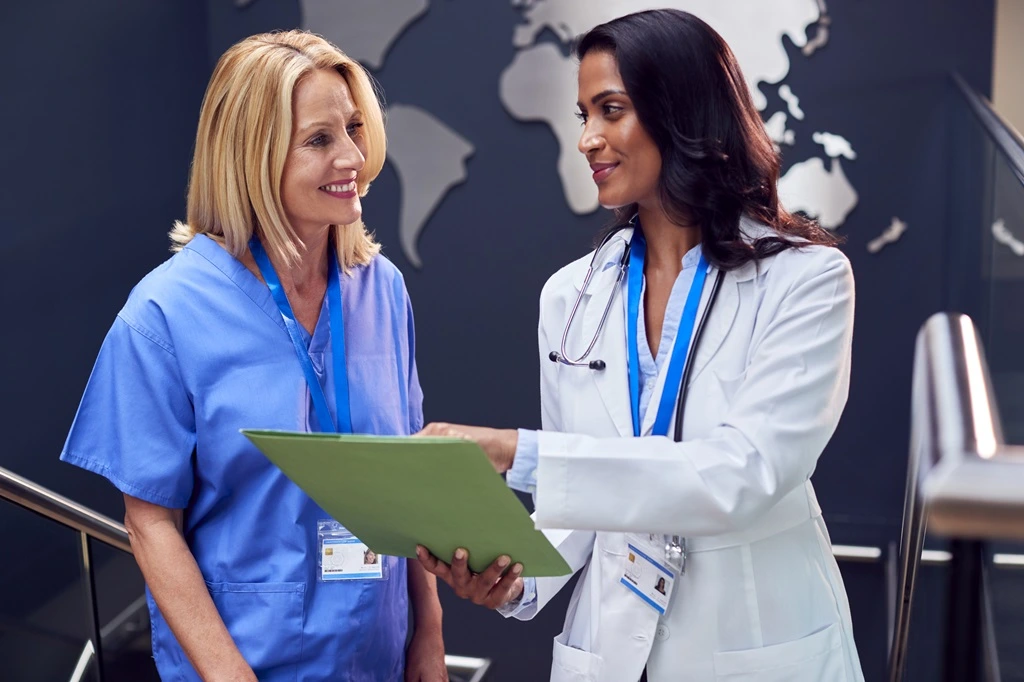 colleagues discussing their travel nurse resume