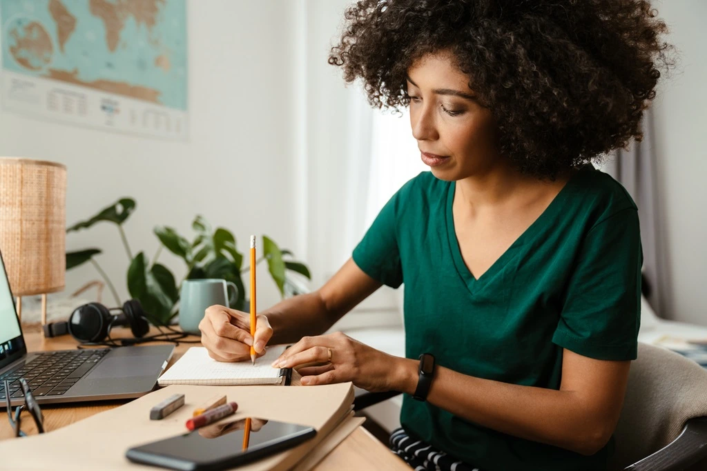 woman taking notes of medical assistant interview questions