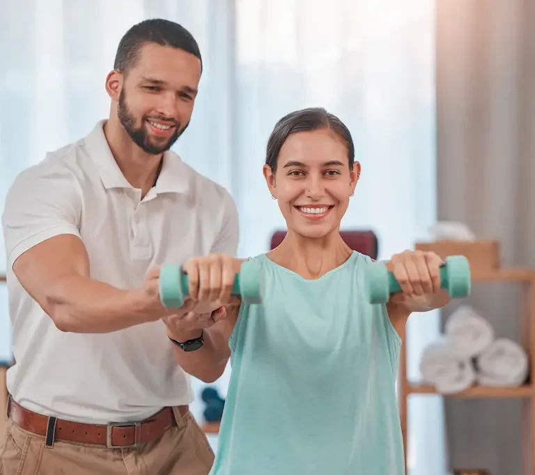 Physical therapist assisting patient with weights, highlighting physical therapist resume skills