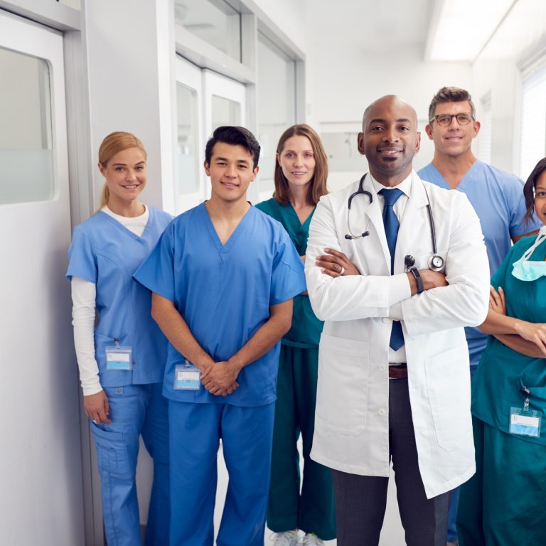 Portrait Of Multi-Cultural Medical Team Standing In Hospital Corridor