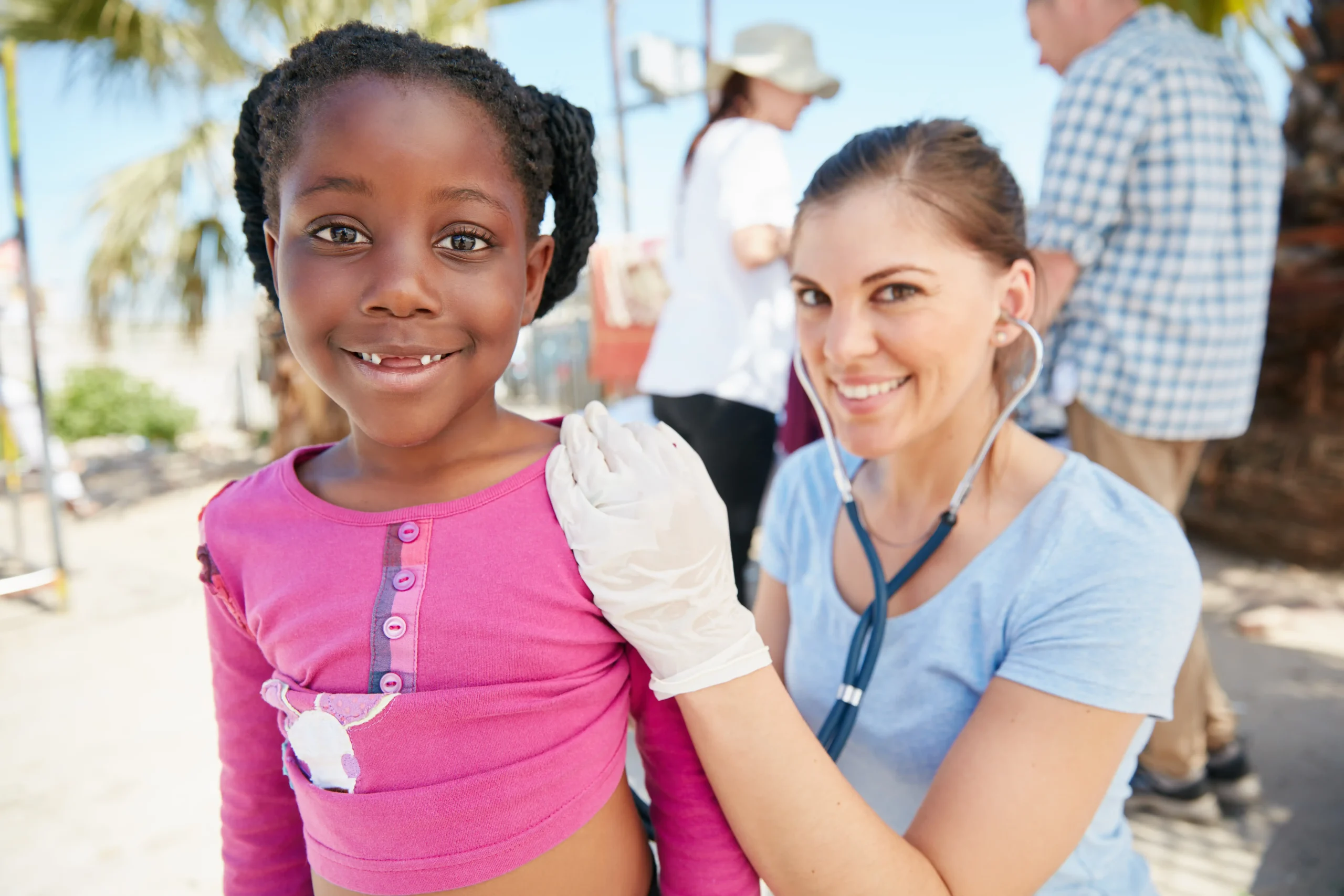 volunteer nurse examines young girl during community outreach, highlighting volunteer work on resume