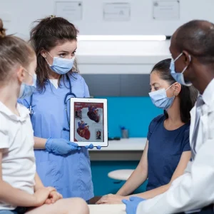 healthcare team showing heart anatomy to patients using patient education skills