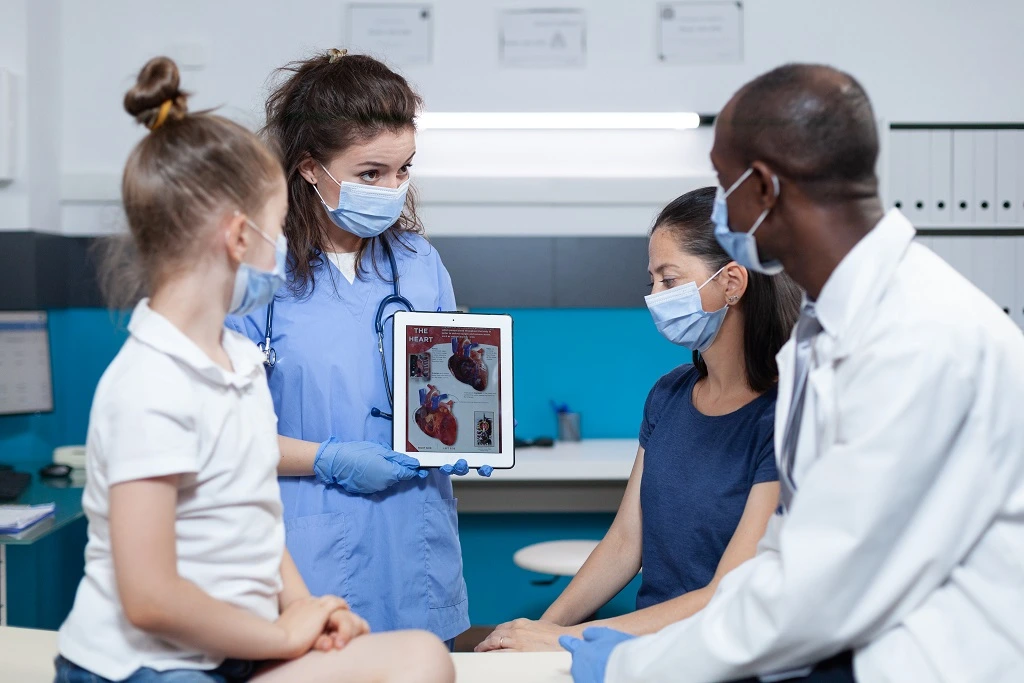 healthcare team showing heart anatomy to patients using patient education skills
