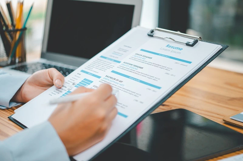 hiring manager reviewing references on resume during candidate evaluation