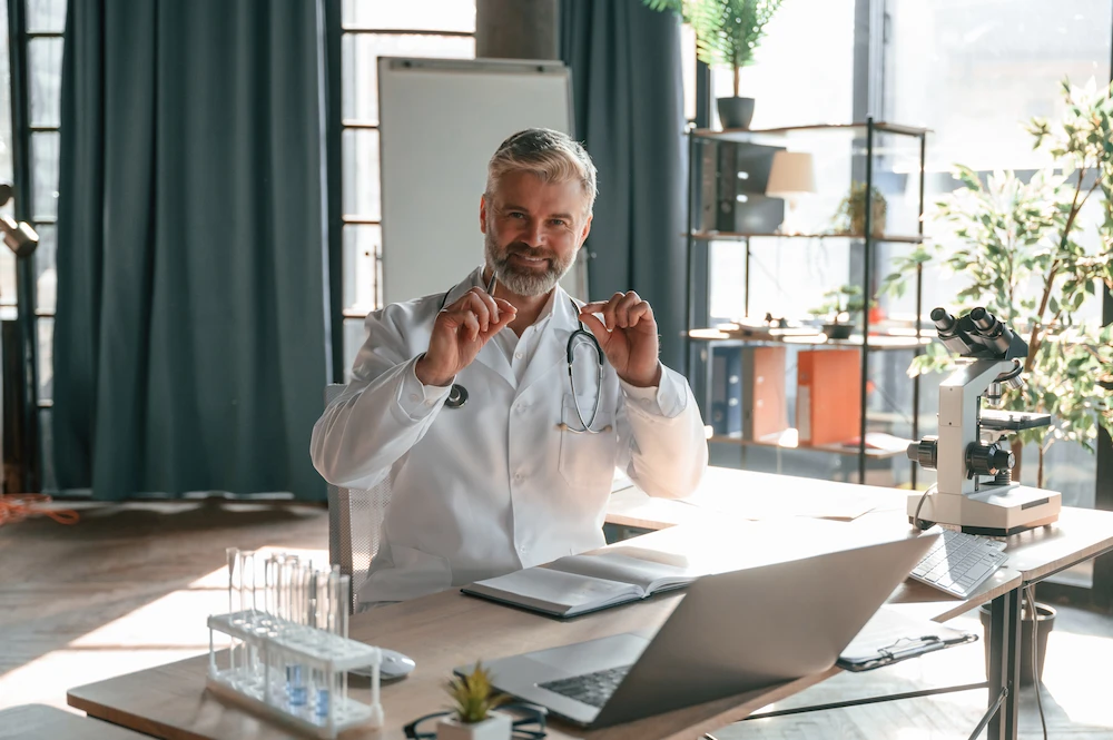 doctor smiling while sitting on office