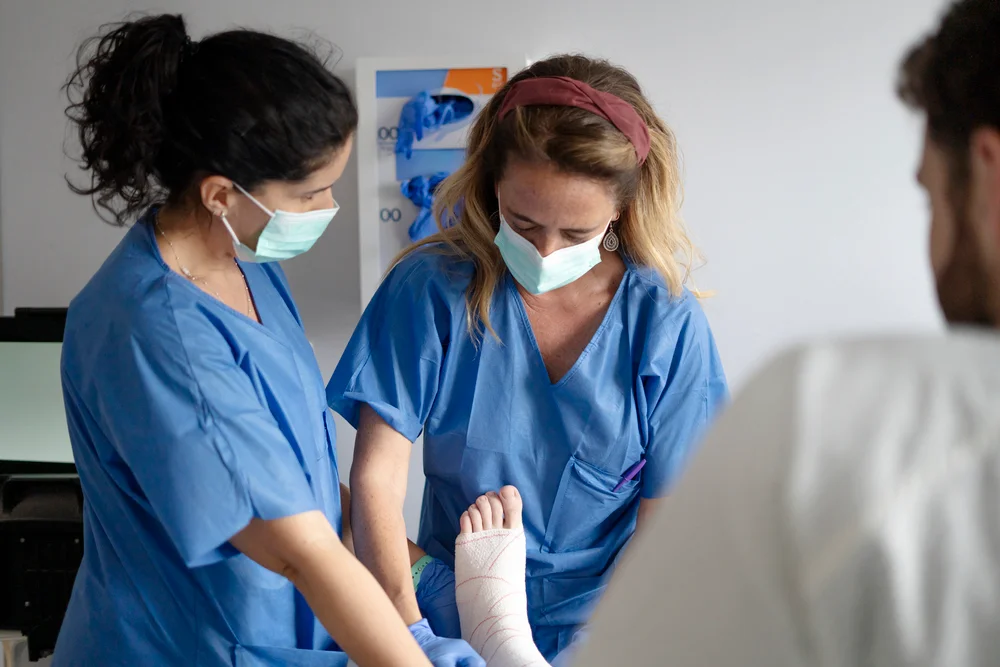 doctors taking care of patient with broken ankle