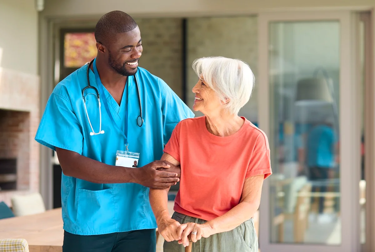 Home Health Aide assisting aged patient